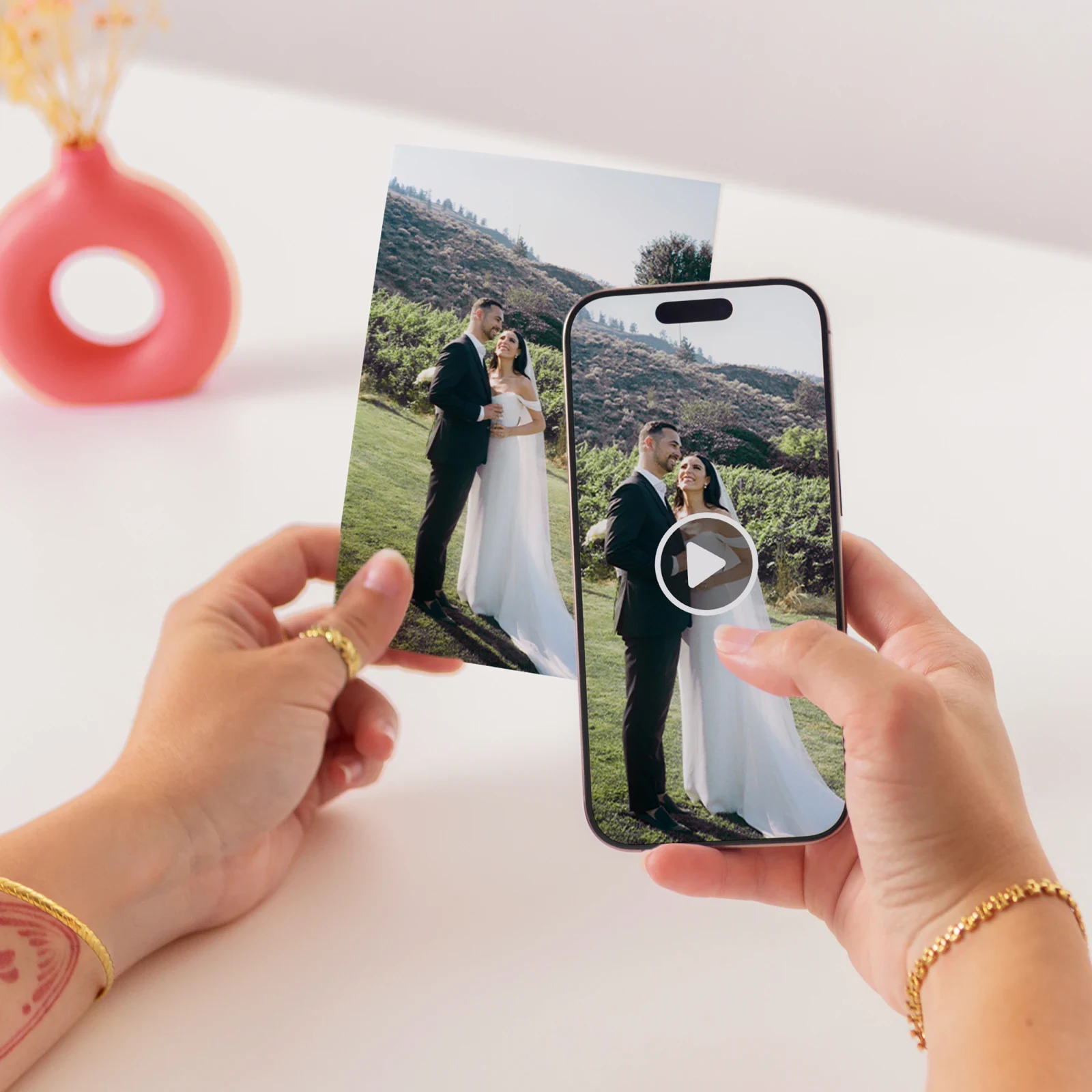 A printed wedding photo and a phone playing the video back