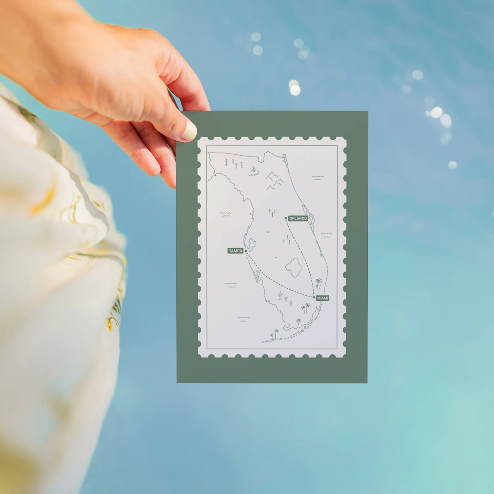 Travel Card — a Florida trip map framed like a stamp, held over water