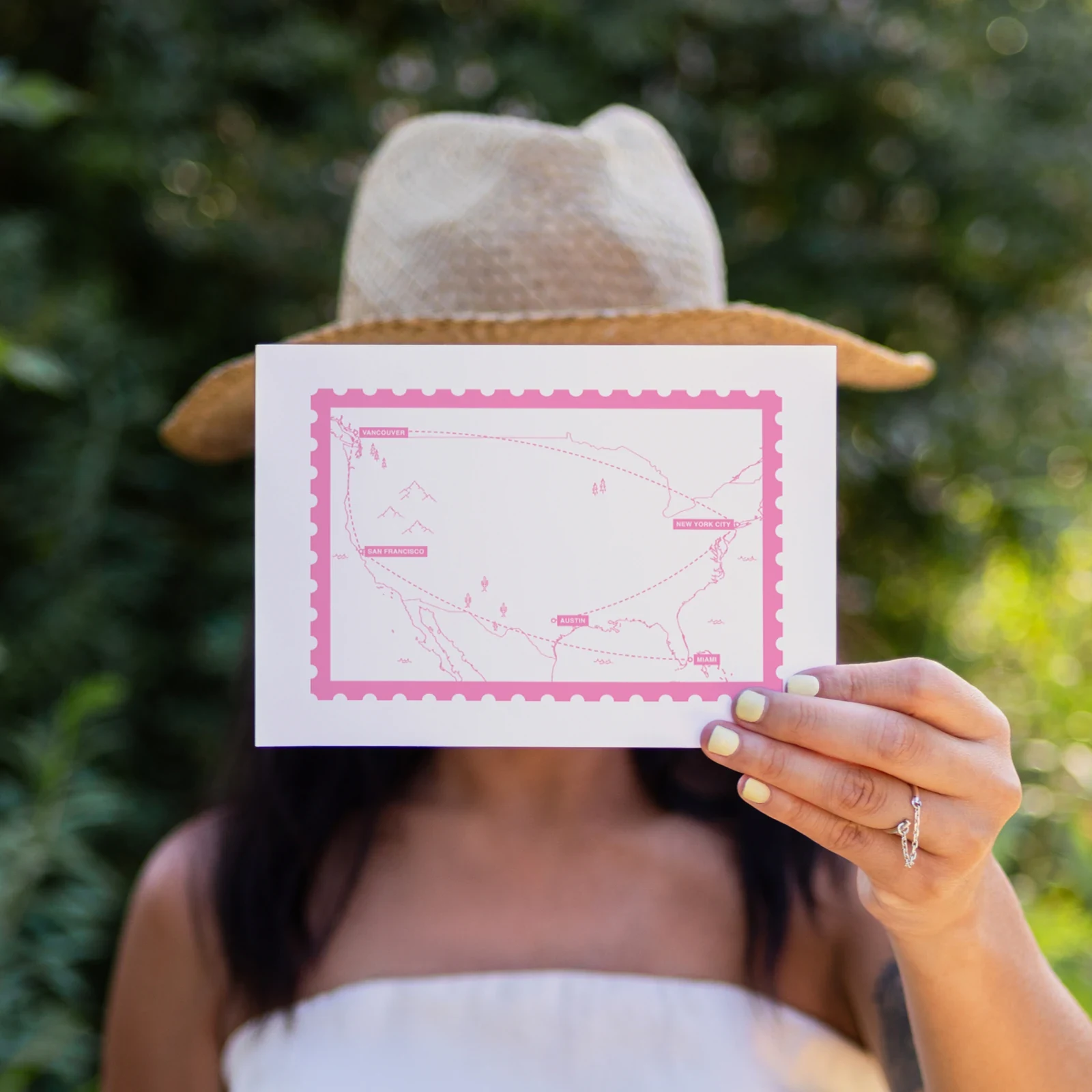 A Travel Card with a pink line-art map of a US trip